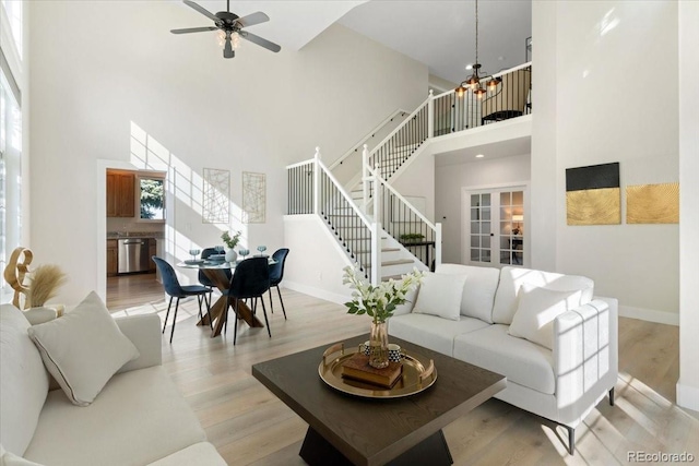 2089 Meadow Sweet Ln, Erie, CO 80516 - living room featuring a high ceiling, stairway, and light wood finished floors