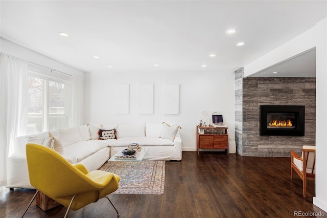 living area featuring a fireplace, recessed lighting, wood finished floors, and baseboards