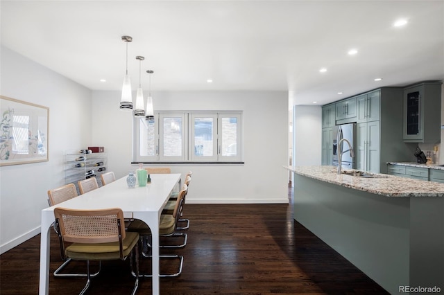 dining room featuring recessed lighting, baseboards, and dark wood finished floors