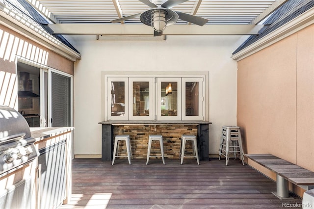 deck featuring an outdoor kitchen, a grill, a pergola, and ceiling fan