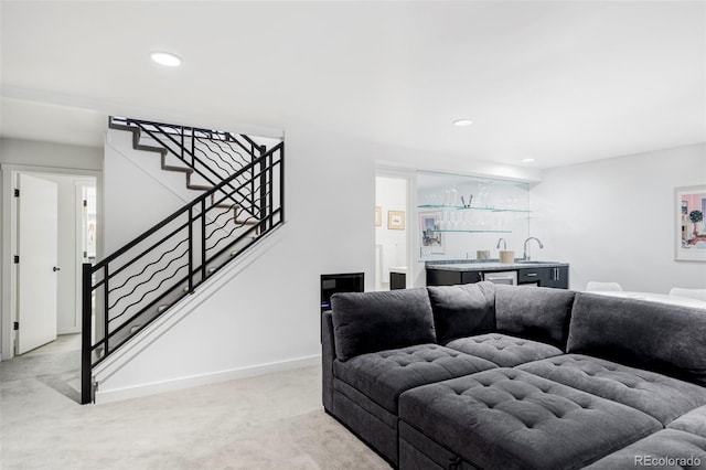 living room featuring light carpet, recessed lighting, stairway, indoor wet bar, and baseboards