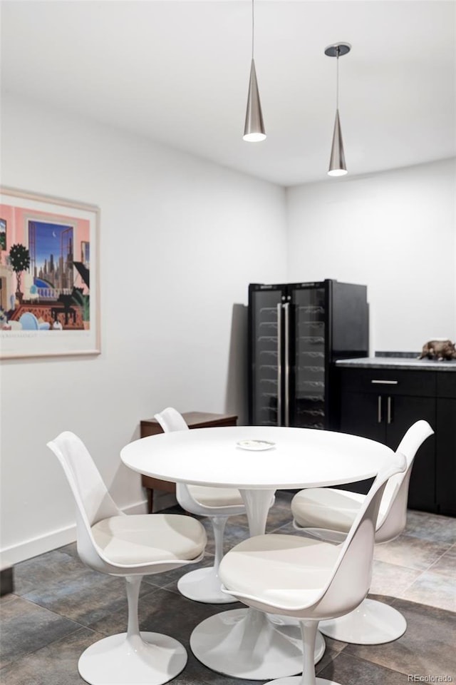 dining area featuring baseboards and stone finish floor