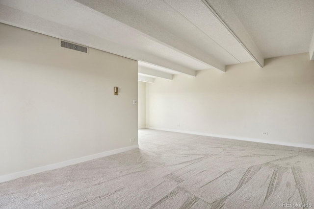 130 N Pearl St Unit 1103, Denver, CO 80203 - carpeted empty room featuring visible vents, a textured ceiling, baseboards, and beamed ceiling