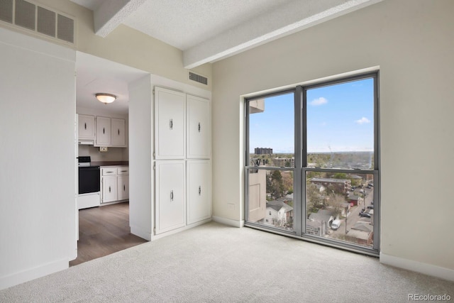 130 N Pearl St Unit 1103, Denver, CO 80203 - unfurnished bedroom featuring beamed ceiling, baseboards, carpet, and visible vents