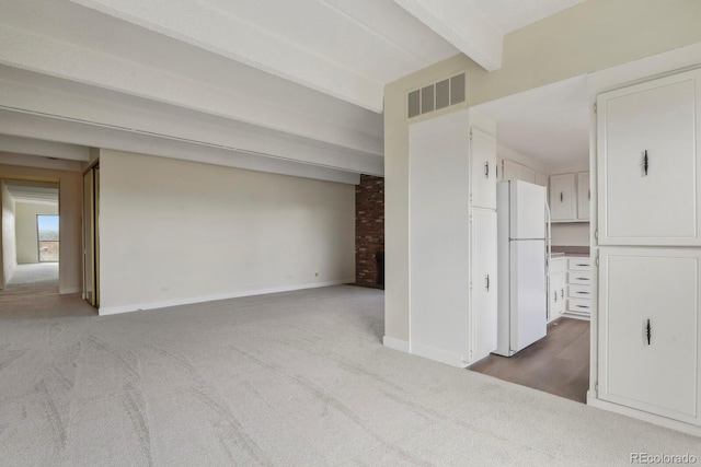 130 N Pearl St Unit 1103, Denver, CO 80203 - unfurnished living room featuring baseboards, carpet flooring, beam ceiling, and visible vents