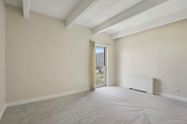 130 N Pearl St Unit 1103, Denver, CO 80203 - empty room featuring baseboards, carpet flooring, a textured ceiling, and beamed ceiling