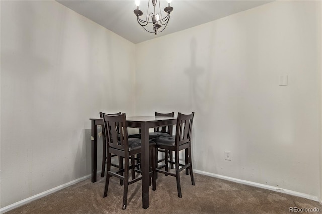 dining area featuring an inviting chandelier and dark carpet