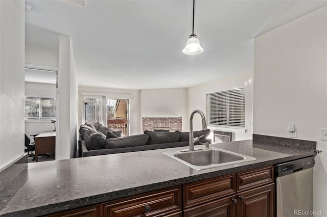 kitchen with stainless steel dishwasher, decorative light fixtures, dark brown cabinets, and sink