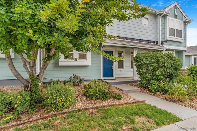 5895 Biscay St Unit D, Denver, CO 80249 - view of property hidden behind natural elements featuring covered porch