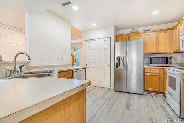 5895 Biscay St Unit D, Denver, CO 80249 - kitchen with appliances with stainless steel finishes, a sink, light wood-style flooring, light countertops, and recessed lighting