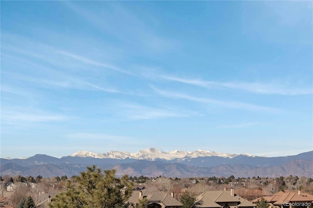 view of mountain background featuring nearby suburban area