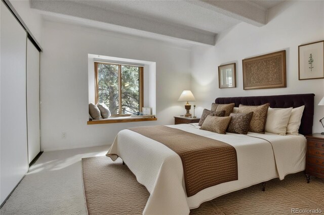 2525 S Dayton Way Unit 1514, Denver, CO 80231 - carpeted bedroom with beam ceiling and a closet