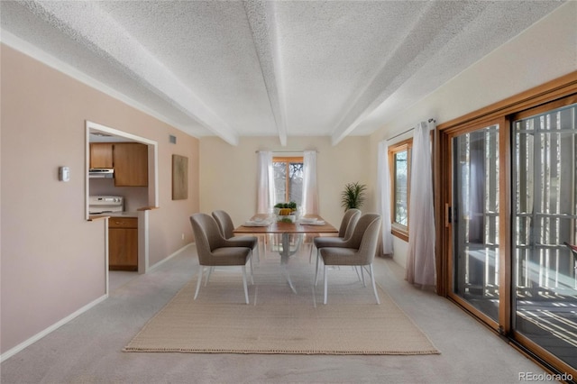 2525 S Dayton Way Unit 1514, Denver, CO 80231 - dining area featuring light carpet, a textured ceiling, baseboards, and beam ceiling