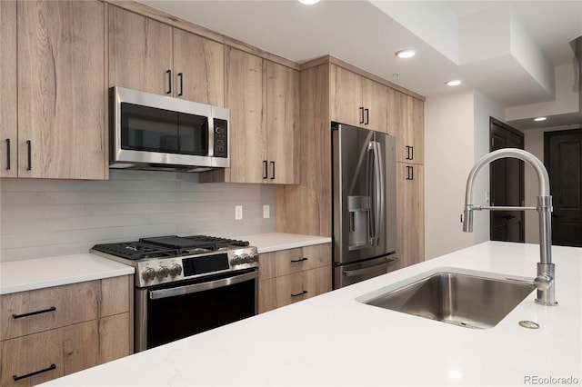 kitchen featuring stainless steel appliances, sink, decorative backsplash, and light brown cabinets