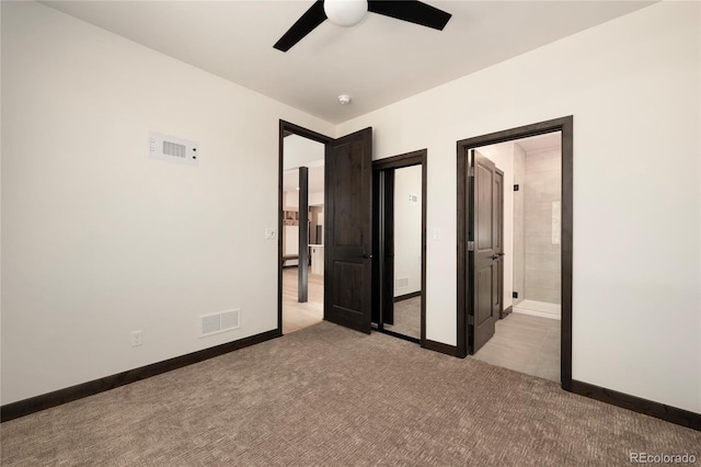 unfurnished bedroom with ceiling fan, light carpet, and ensuite bath