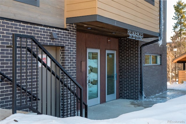 view of snow covered property entrance