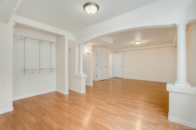 interior space with ornate columns and hardwood / wood-style flooring