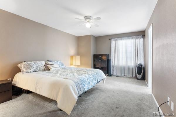 bedroom featuring light colored carpet and ceiling fan