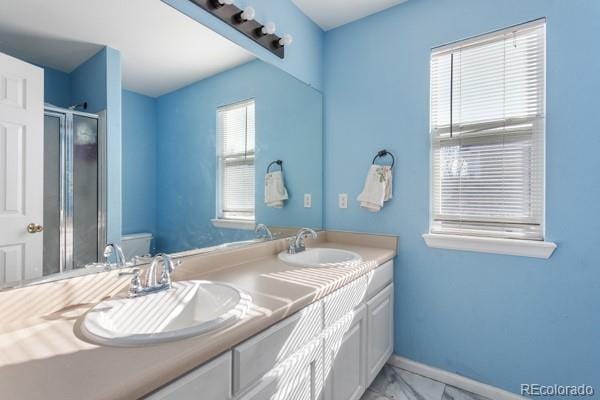 bathroom with vanity, an enclosed shower, and toilet