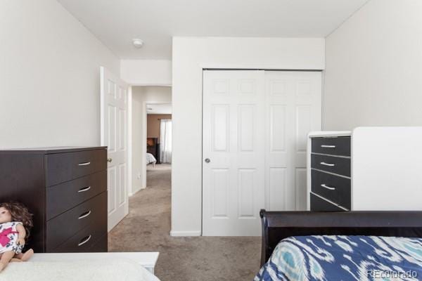 bedroom featuring a closet and light carpet