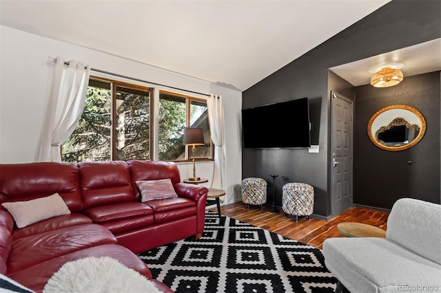 living area with lofted ceiling and wood finished floors