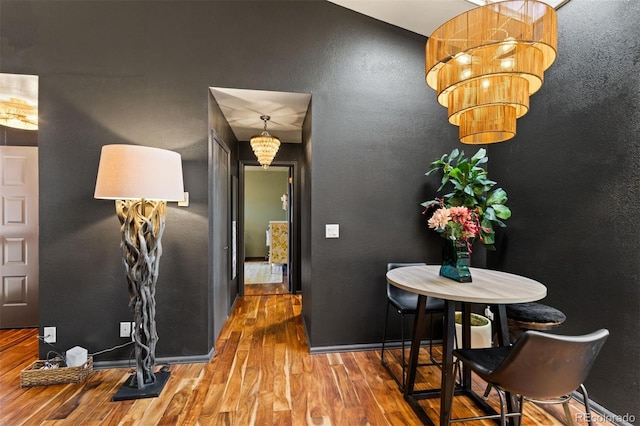 corridor featuring wood finished floors and a textured wall