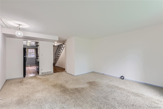 1200 S Monaco St Parkway Unit 31, Denver, CO 80224 - unfurnished living room featuring stairs and carpet flooring