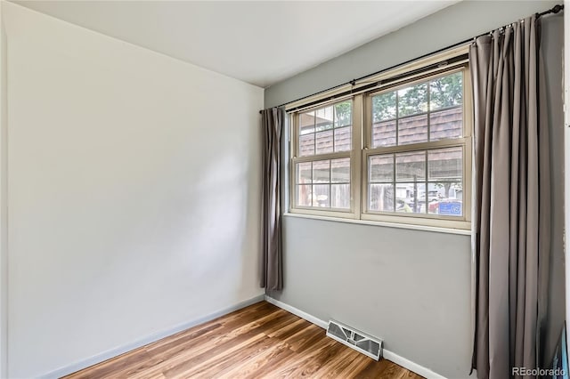 1200 S Monaco St Parkway Unit 31, Denver, CO 80224 - spare room with baseboards and wood finished floors