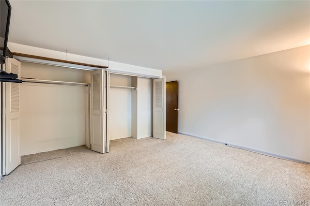 1200 S Monaco St Parkway Unit 31, Denver, CO 80224 - unfurnished bedroom with light carpet and two closets