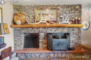 6100 Waterbarrel Rd, Beulah, CO 81023 - detailed view of a wood stove and baseboards