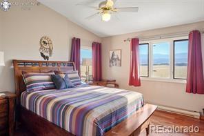 6100 Waterbarrel Rd, Beulah, CO 81023 - bedroom with lofted ceiling, ceiling fan, and wood finished floors