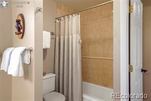 6100 Waterbarrel Rd, Beulah, CO 81023 - bathroom featuring toilet and shower / bath combo with shower curtain