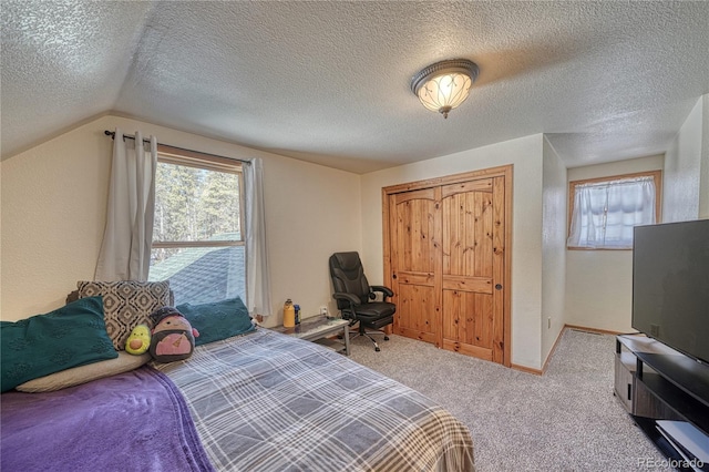 bedroom featuring baseboards, lofted ceiling, a textured ceiling, and carpet flooring