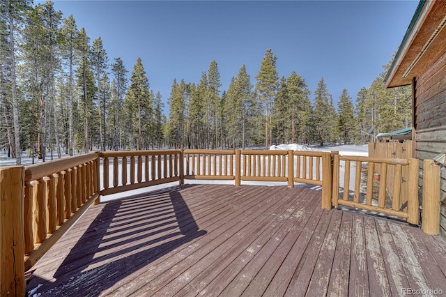 wooden terrace with a view of trees