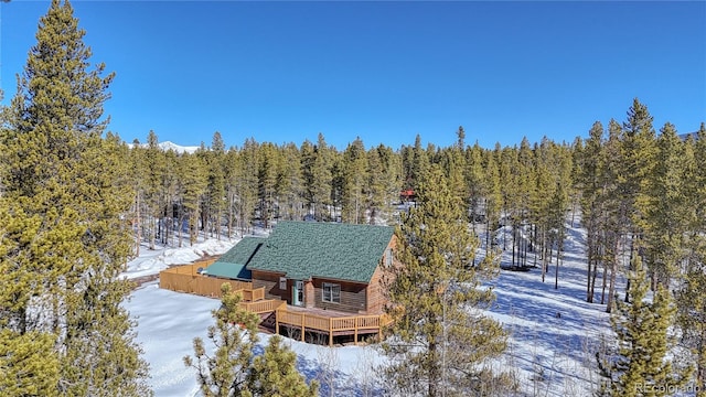 snowy aerial view with a forest view