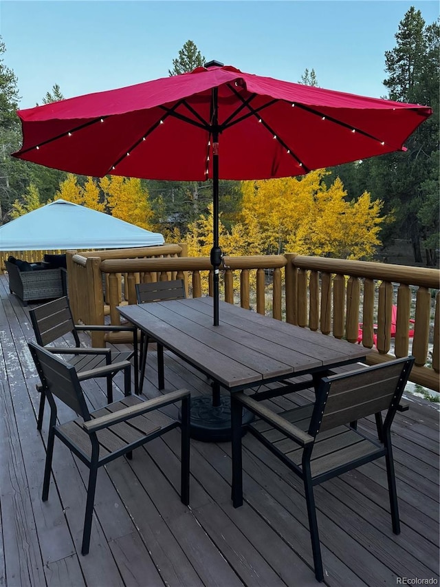 wooden terrace featuring outdoor dining area