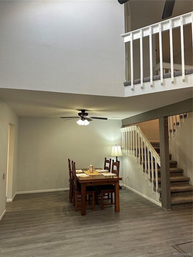 dining space featuring dark wood-type flooring and ceiling fan