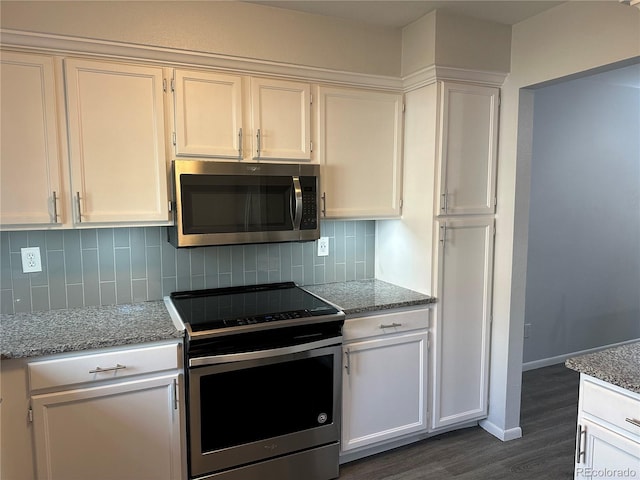 kitchen with white cabinetry, light stone countertops, and appliances with stainless steel finishes