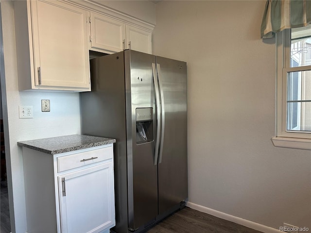 kitchen featuring dark hardwood / wood-style floors, white cabinets, and stainless steel refrigerator with ice dispenser