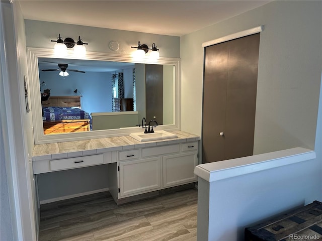 bathroom featuring vanity, hardwood / wood-style floors, and ceiling fan