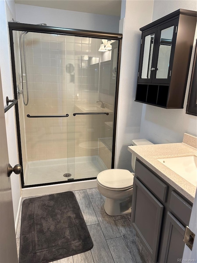 bathroom with vanity, toilet, and walk in shower