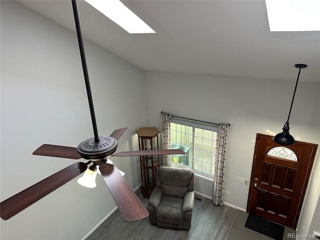 sitting room featuring dark hardwood / wood-style flooring and a skylight