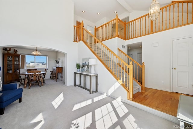 16275 Electra St, Brighton, CO 80603 - living area with an inviting chandelier, arched walkways, stairs, and high vaulted ceiling