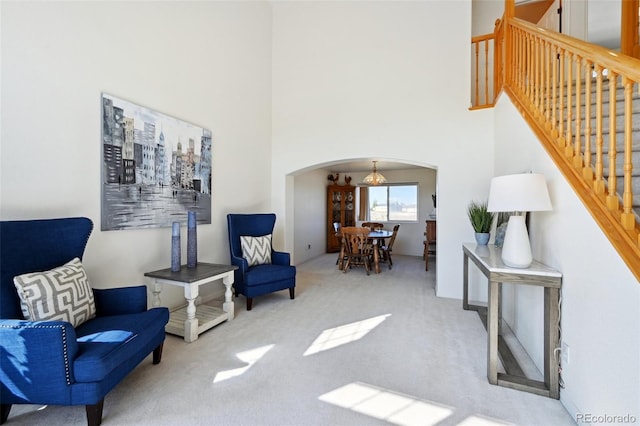 16275 Electra St, Brighton, CO 80603 - living area with carpet floors, arched walkways, stairs, and a high ceiling