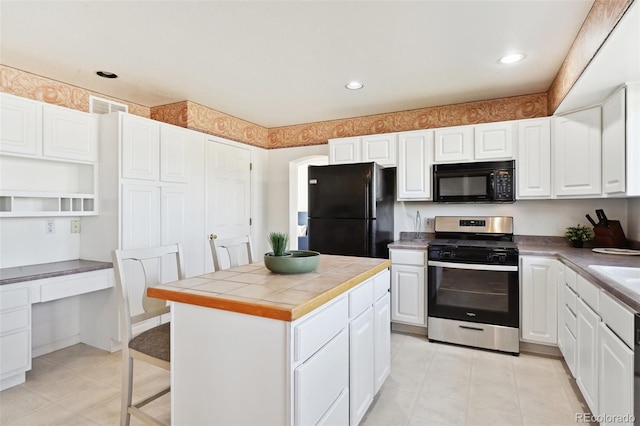 16275 Electra St, Brighton, CO 80603 - kitchen with visible vents, tile counters, recessed lighting, white cabinets, and black appliances