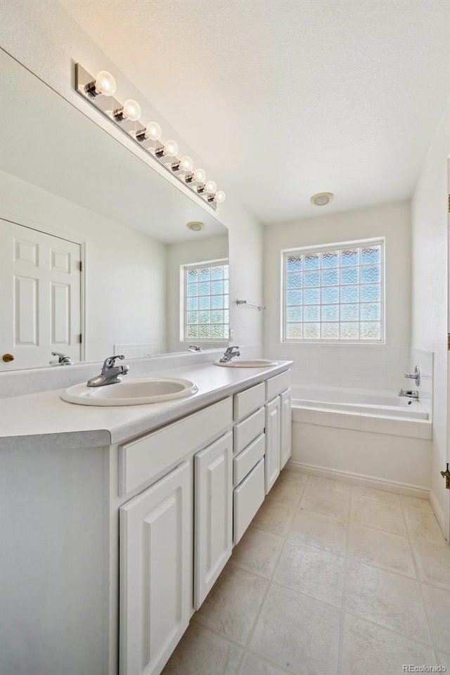 16275 Electra St, Brighton, CO 80603 - full bath with double vanity, a sink, a bath, and tile patterned flooring