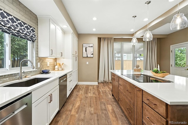 4253 Lark Sparrow St, Highlands Ranch, CO 80126 - kitchen featuring stainless steel dishwasher, black electric stovetop, recessed lighting, light wood-style flooring, and decorative backsplash