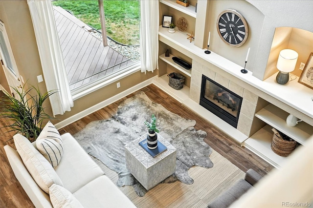 4253 Lark Sparrow St, Highlands Ranch, CO 80126 - living room featuring wood finished floors, a premium fireplace, and built in shelves