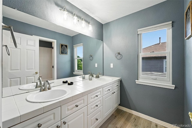 4253 Lark Sparrow St, Highlands Ranch, CO 80126 - bathroom with double vanity and wood finished floors