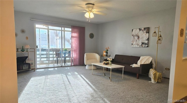 carpeted living room with ceiling fan